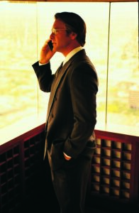 A man talking on a wireless phone
